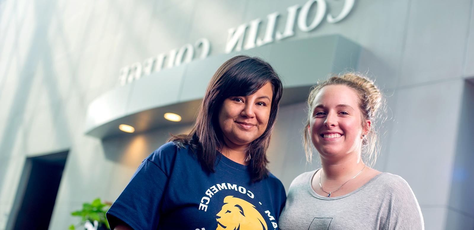 Two females smiling at the camera.